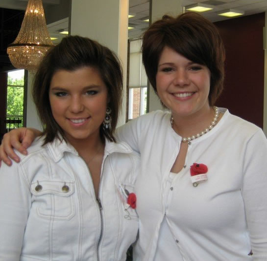Two young women in white dresses. (Though you cannot tell from the picture, these two ladies are sisters)
