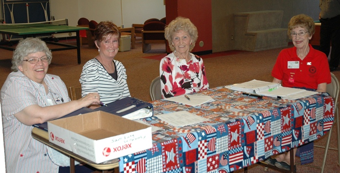 Women sit at the registration table